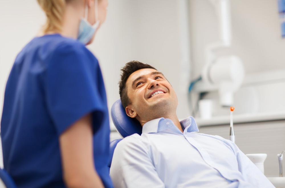 oral health dunedin | man smiling in dental chair 