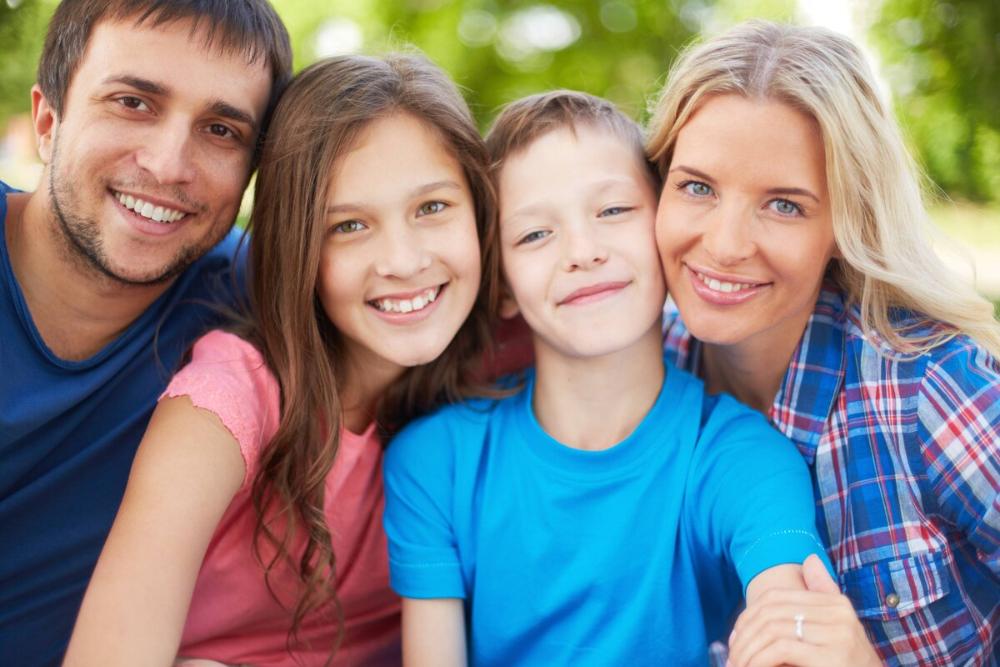 mom, dad, daughter, and son smiling