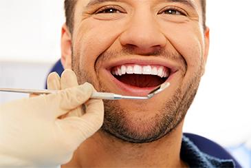 gum disease treatment dunedin | man at dentist