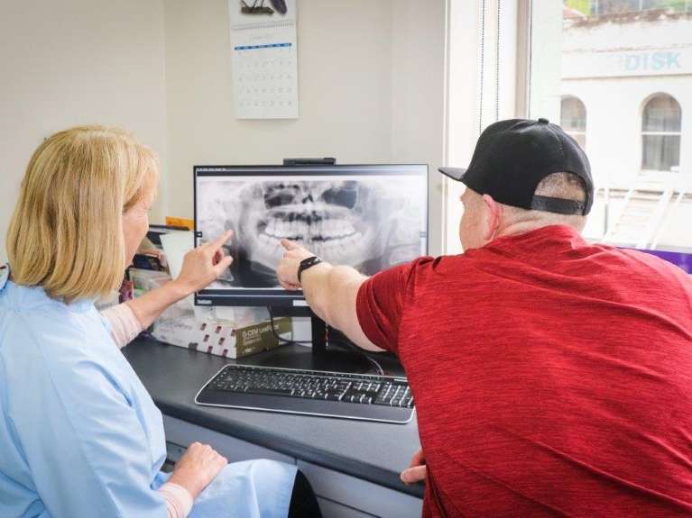 Patient and Dunedin, NZ dentist looking at digital x-ray scans