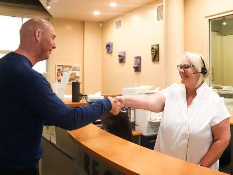 Dental patient shaking hands with staff at dentist in Dunedin, Otago NZ