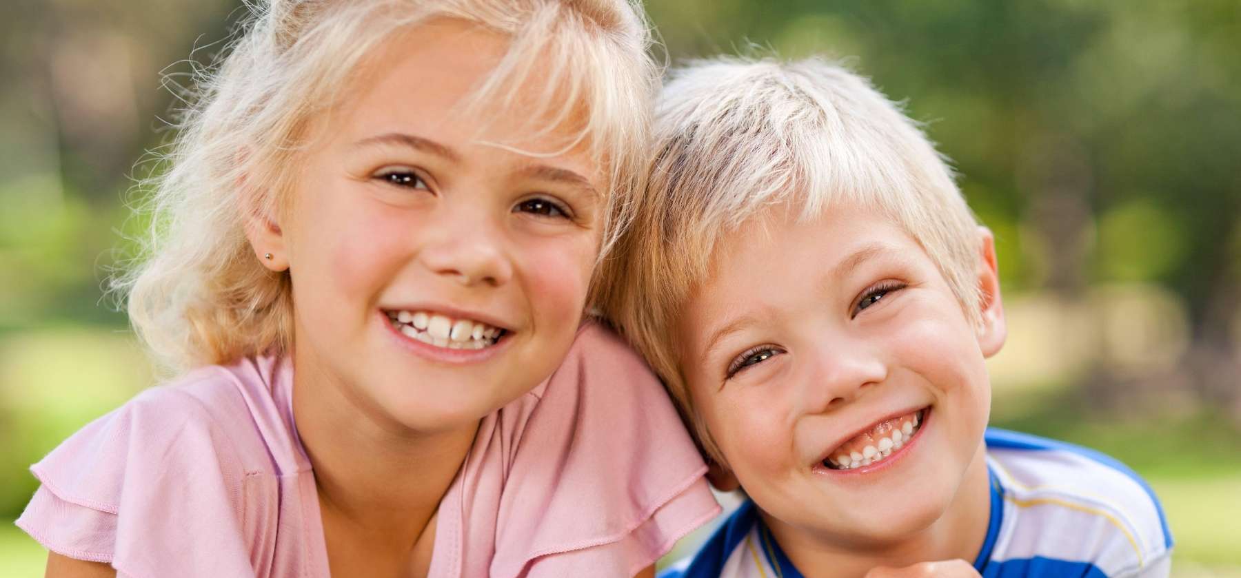 young brother and sister smiling in dunedin