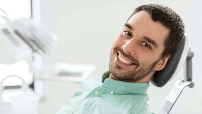 man smiling after getting a dental clinic in dunedin