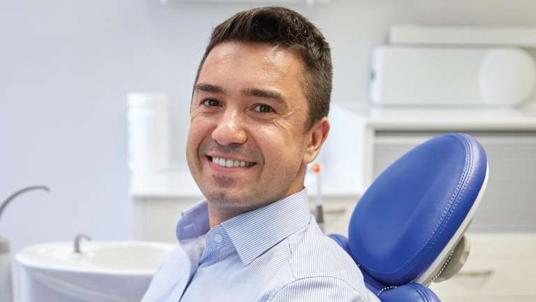 gum disease treatment dunedin | man at dentist