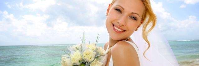 woman smiling while wearing a wedding dress 