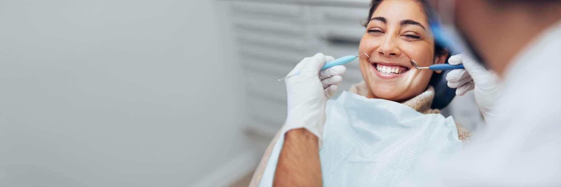 Woman smiling during treatment at Dunedin dentist 