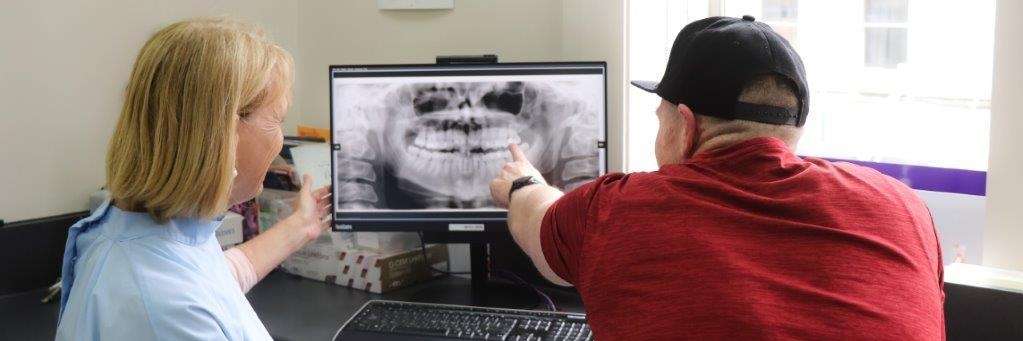 Dentist in Dunedin, NZ showing patient a digital x-ray scan