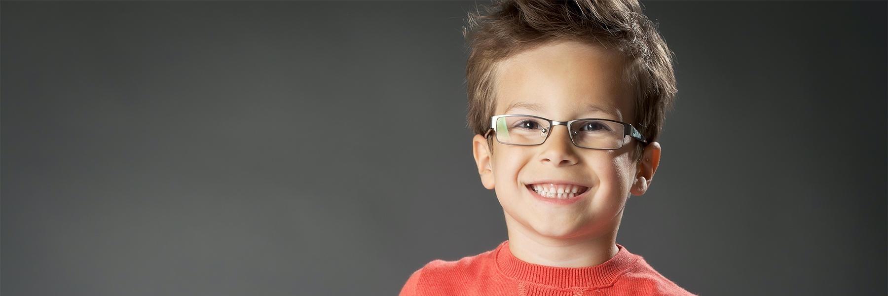 Child smiling at family dentist in Dunedin